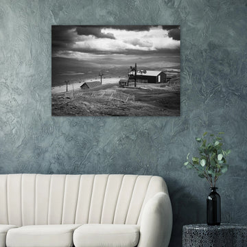Glencoe Mountain View wall art showing a black and white panorama from Glencoe Mountain with ski lifts, small huts and a wide Highland landscape under dramatic clouds