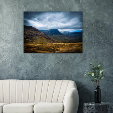 Buachaille Etive Mòr Glencoe wall art showing the dark pyramid-shaped mountain in the centre of a rocky Highland glen under heavy clouds and cool blue light