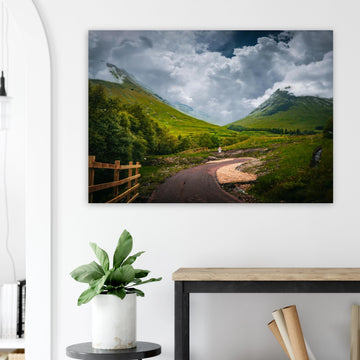 Glencoe orbital route stormy sky wall art with path leading through trees towards Pap of Glencoe under dark clouds