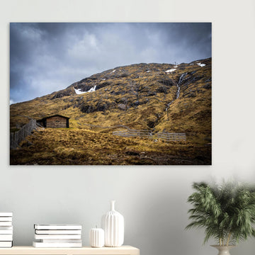 Glencoe Mountain Ski Lift Top wall art showing a wooden hut and fences on a rocky hillside with ski lift towers, snow patches and grey clouds at Glencoe Mountain Resort