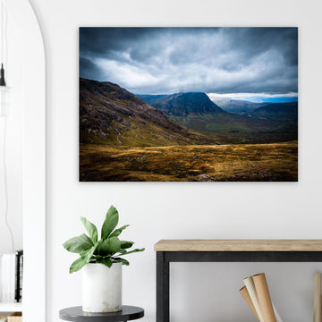 Buachaille Etive Mòr Glencoe wall art showing the dark pyramid-shaped mountain in the centre of a rocky Highland glen under heavy clouds and cool blue light