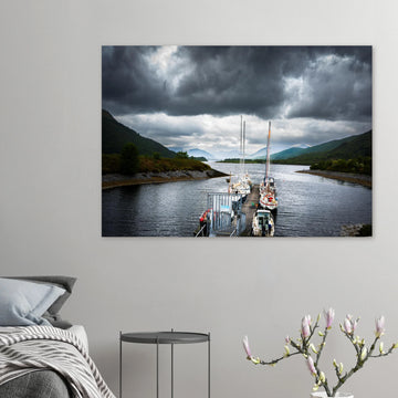 Ballachulish Harbour wall art showing yachts lined up along a narrow pier between green hills with dark storm clouds over the Scottish waterway
