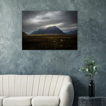 Buachaille Etive Mòr stormy sunrise wall art showing the dark Glencoe mountain under heavy clouds with a strip of light over the foreground moorland