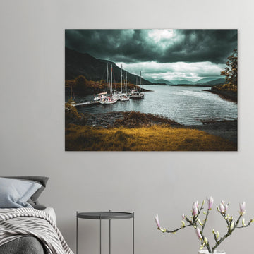 Ballachulish dockyard wall art showing yachts moored at a small dock with dark hills, teal water and heavy storm clouds on the Scottish west coast