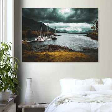 Ballachulish dockyard wall art showing yachts moored at a small dock with dark hills, teal water and heavy storm clouds on the Scottish west coast