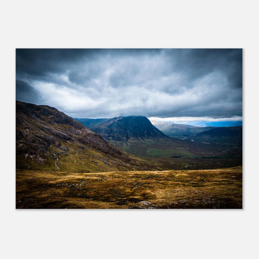 Buachaille Etive Mòr Glencoe wall art showing the dark pyramid-shaped mountain in the centre of a rocky Highland glen under heavy clouds and cool blue light