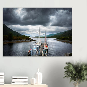 Ballachulish Harbour wall art showing yachts lined up along a narrow pier between green hills with dark storm clouds over the Scottish waterway