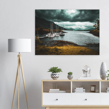 Ballachulish dockyard wall art showing yachts moored at a small dock with dark hills, teal water and heavy storm clouds on the Scottish west coast