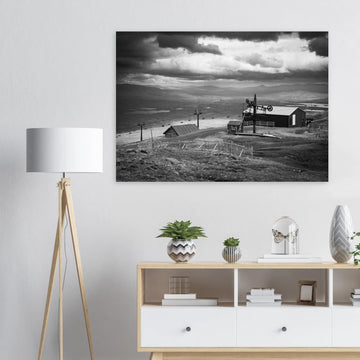 Glencoe Mountain View wall art showing a black and white panorama from Glencoe Mountain with ski lifts, small huts and a wide Highland landscape under dramatic clouds