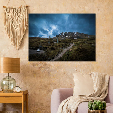 Glencoe Ski Lift wall art showing empty chairlifts climbing a rugged hillside towards snow patches with dramatic blue-grey clouds over Glencoe Mountain Resort