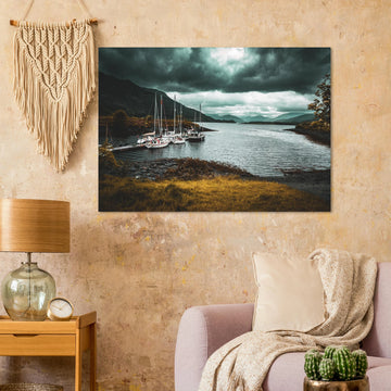 Ballachulish dockyard wall art showing yachts moored at a small dock with dark hills, teal water and heavy storm clouds on the Scottish west coast