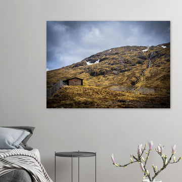 Glencoe Mountain Ski Lift Top wall art showing a wooden hut and fences on a rocky hillside with ski lift towers, snow patches and grey clouds at Glencoe Mountain Resort