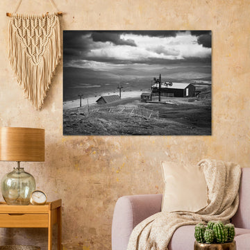 Glencoe Mountain View wall art showing a black and white panorama from Glencoe Mountain with ski lifts, small huts and a wide Highland landscape under dramatic clouds