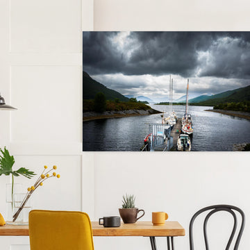 Ballachulish Harbour wall art showing yachts lined up along a narrow pier between green hills with dark storm clouds over the Scottish waterway
