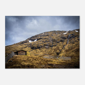 Glencoe Mountain Ski Lift Top wall art showing a wooden hut and fences on a rocky hillside with ski lift towers, snow patches and grey clouds at Glencoe Mountain Resort